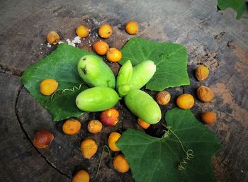High angle view of fruits and leaves on table