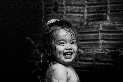 Close-up portrait of shirtless girl at fountain