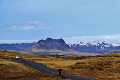 Scenic view of snowcapped mountains against sky