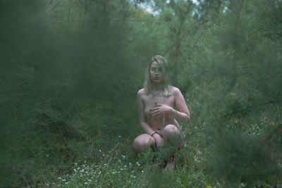 Woman sitting in a forest