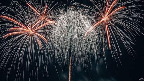 Low angle view of firework display at night