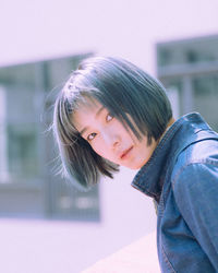 Close-up portrait of woman with short hair at city