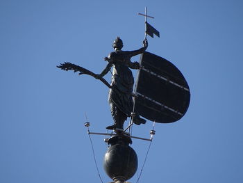 Low angle view of weather vane against clear sky