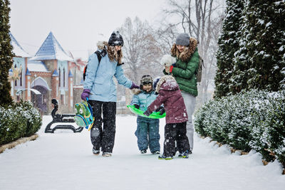 Outdoors winter activities for family, friends. happy family, friends, two women, two boy kids and