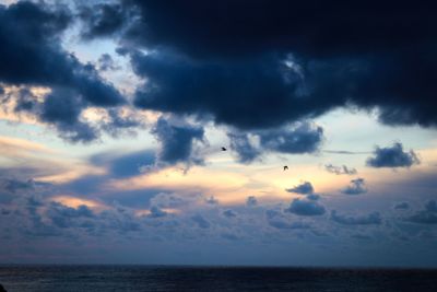 Scenic view of sea against dramatic sky