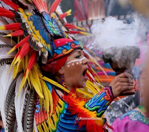 Close-up of woman with multi colored umbrella