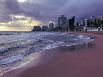 Scenic view of sea and buildings against sky