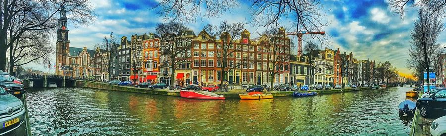 Boats in river with buildings in background