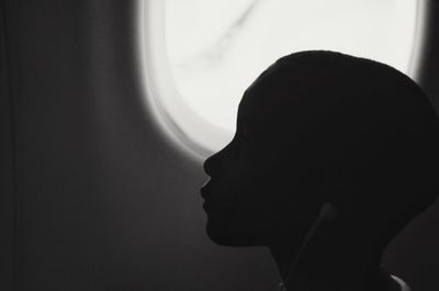 Woman looking through window