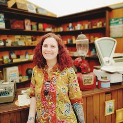 Portrait of smiling woman standing in store