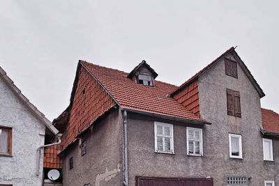 Low angle view of buildings in town against sky