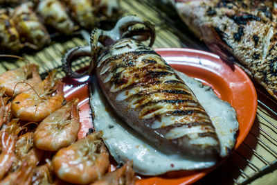 High angle view of fish on barbecue grill