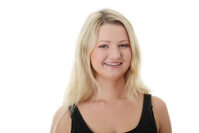 Portrait of smiling woman against white background