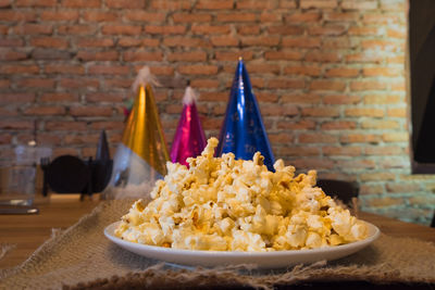 Close-up of food on table against wall