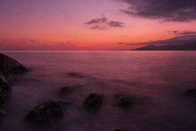 Scenic view of sea against romantic sky at sunset