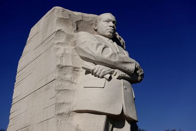 Low angle view of statue against clear blue sky