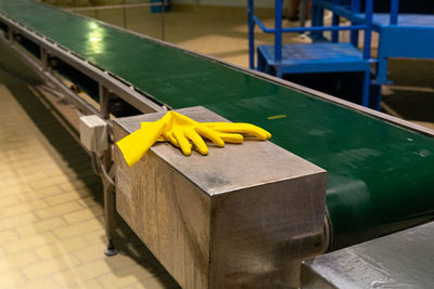 High angle view of yellow hand on table 