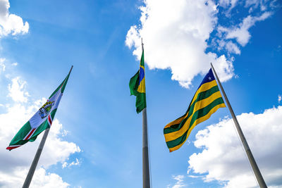 Low angle view of flags flag against sky