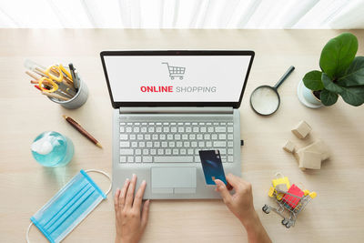 High angle view of man using laptop on table