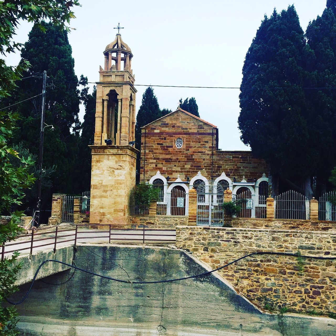 architecture, built structure, building exterior, place of worship, religion, tree, spirituality, church, clear sky, history, low angle view, sky, facade, old, day, outdoors, no people, travel destinations