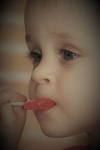 Close-up of boy eating lollipop
