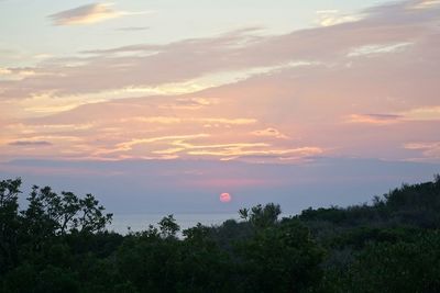 Scenic view of landscape against sky at sunset