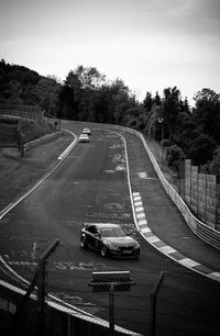 High angle view of cars on road against sky