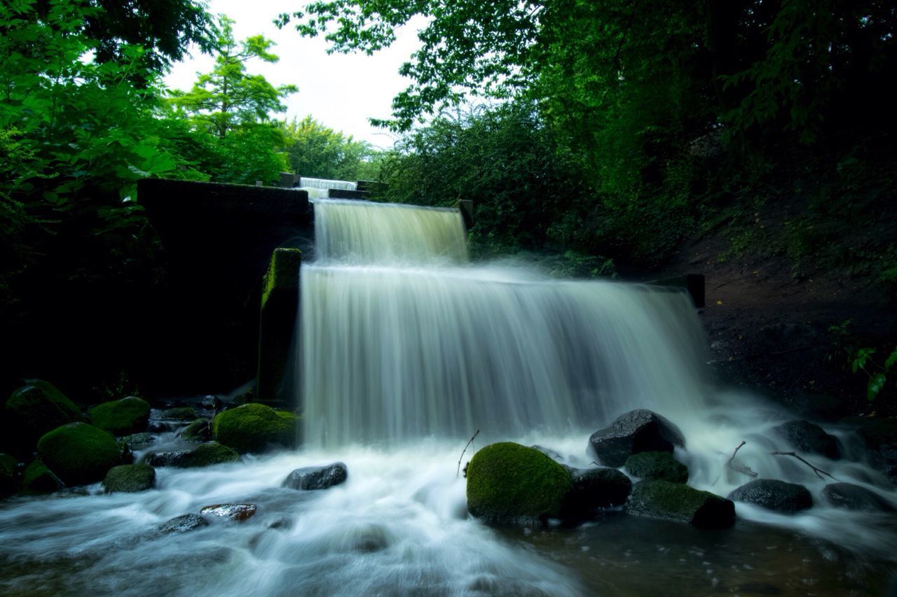 waterfall, motion, water, long exposure, tree, flowing water, scenics, forest, flowing, beauty in nature, speed, rock - object, blurred motion, nature, rock, environment, power in nature, day, purity, stream, tranquil scene, lush foliage, growth, outdoors, tranquility, non urban scene, green color, non-urban scene, falling water, remote, bridge, splashing