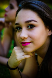 Close-up portrait of young woman wearing pink lipstick