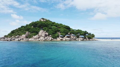 Scenic view of island against cloudy sky