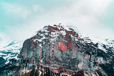 View of snow on rock formation against sky