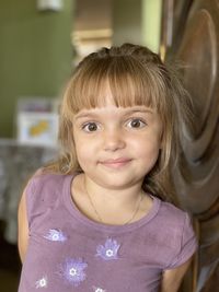 Portrait of cute smiling girl at home