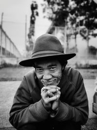 Portrait of happy senior man sitting outdoors