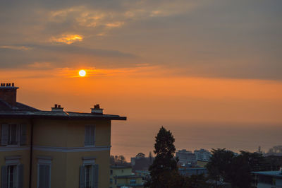 Silhouette buildings against sky during sunset