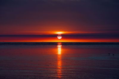 Scenic view of sea against romantic sky at sunset