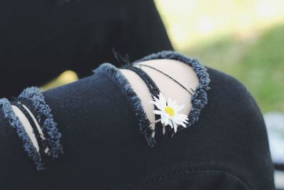 Close-up of woman by flowering plant