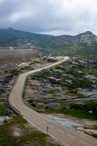 High angle view of road by mountain against sky