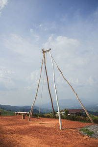 View of wind turbines on field against sky