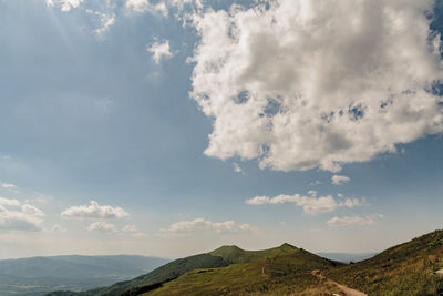 Low angle view of land against cloudy sky