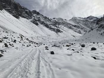 Scenic view of snow covered mountains against sky