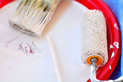 High angle view of paintbrushes in plate on table