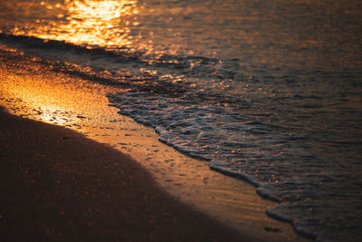 Close-up of beach during sunset