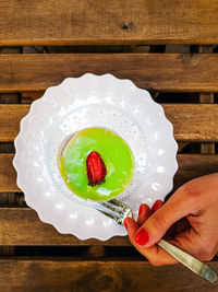 Midsection of person holding ice cream in plate