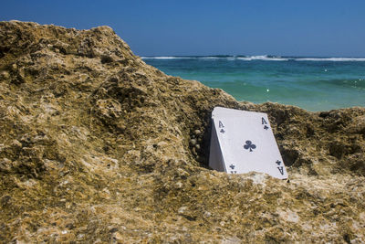 Scenic view of rocks on beach against clear sky