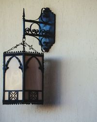 Close-up of lamp against wall at home