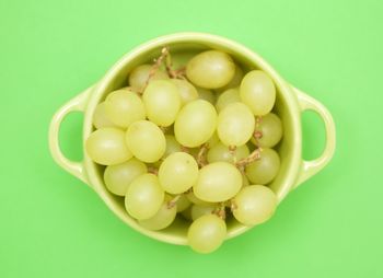 Close-up of grapes over white background