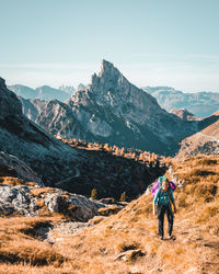 Woman on mountains against sky