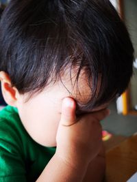 Close-up portrait of boy with hands