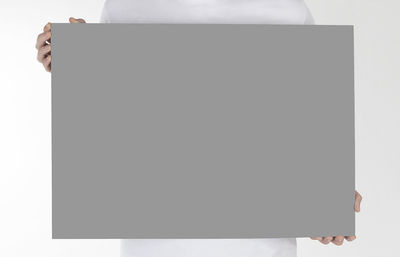 Low angle view of a woman standing against white background
