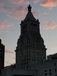 Low angle view of tower against sky at sunset